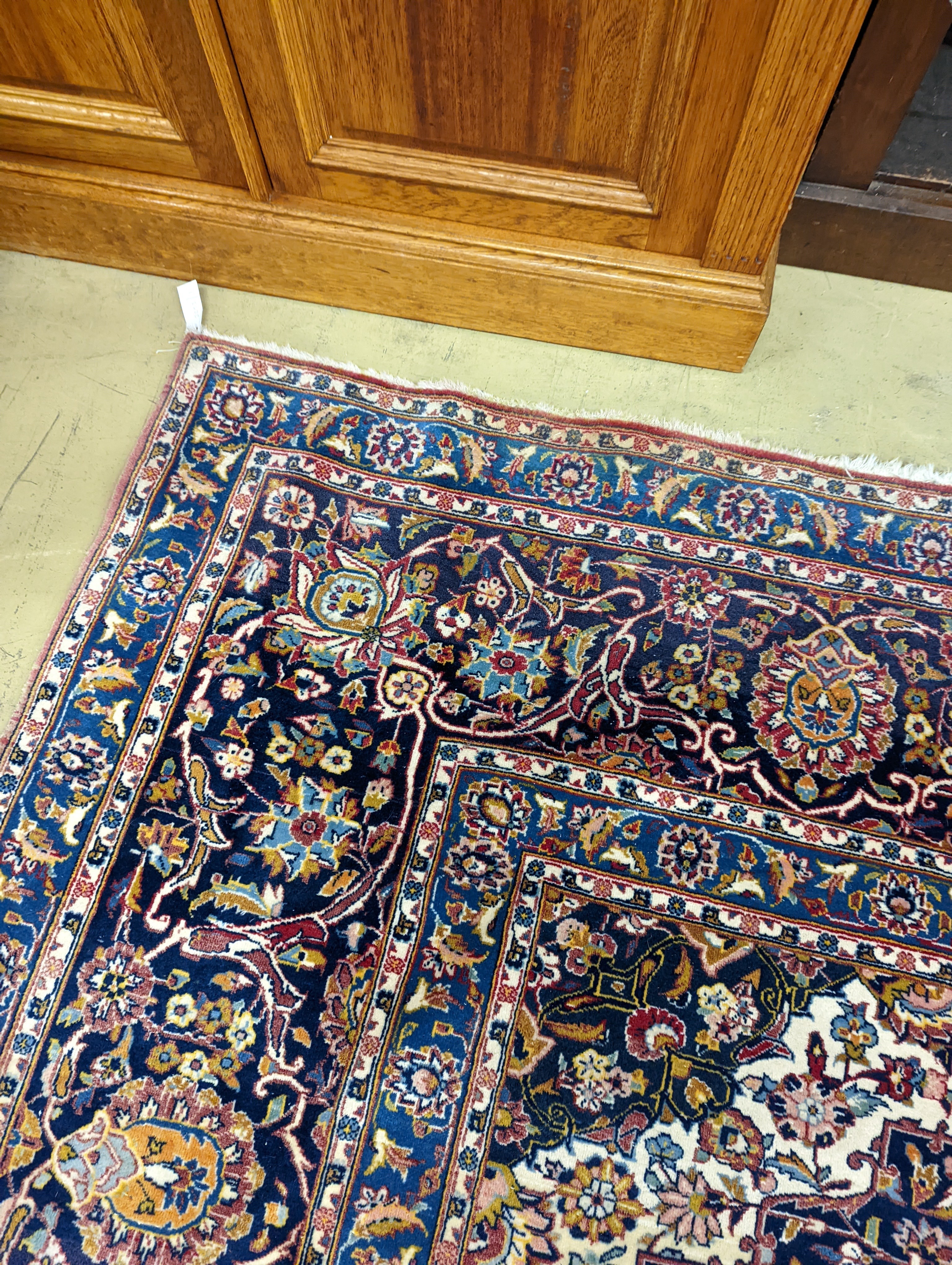 A large Tabriz red ground floral carpet, 540 x 350cm